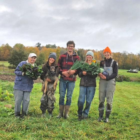 group of farmers holding produce